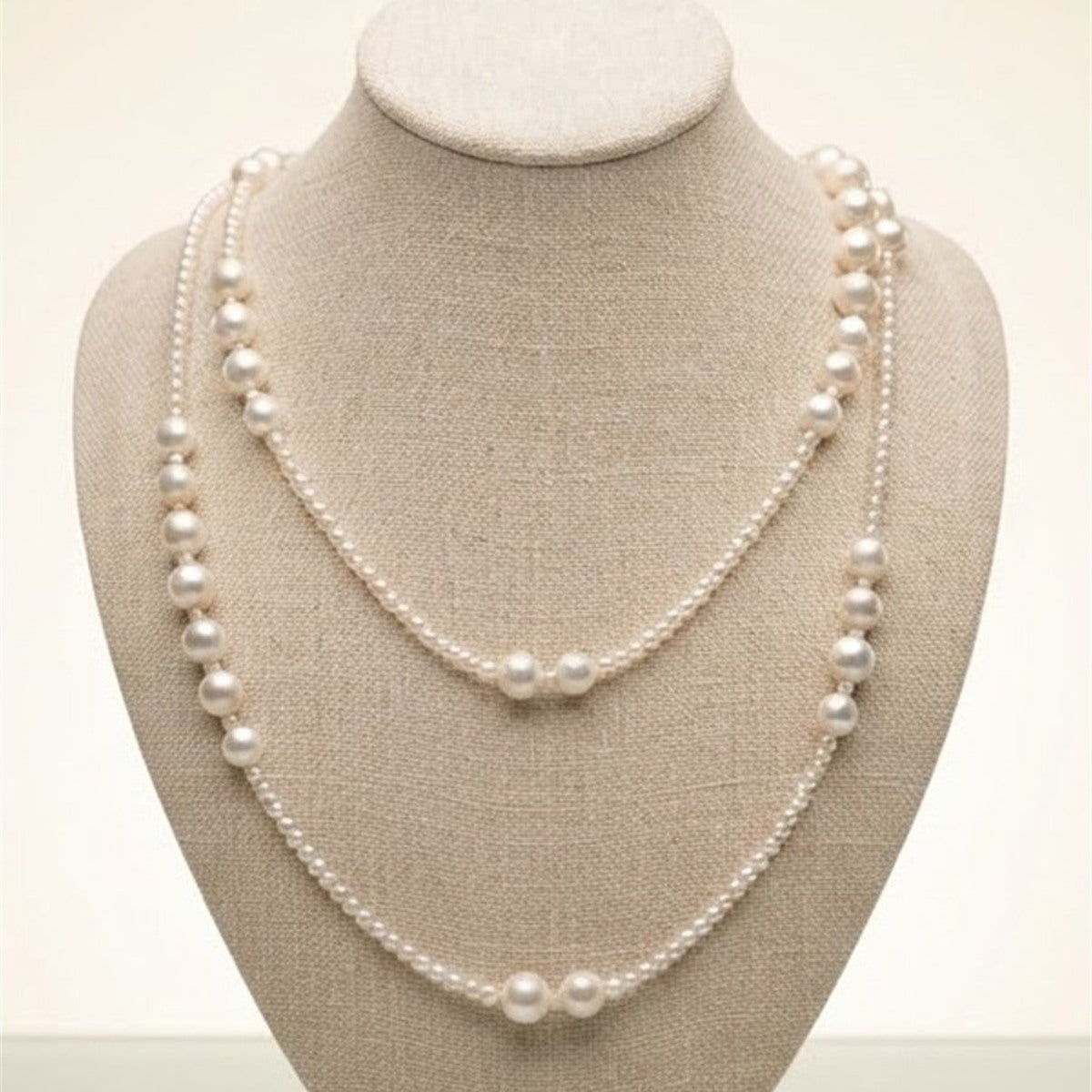 Long freshwater pearl layering necklace on a display bust
