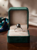 Tahitian pearl ring with sparkling side stones in a green velvet box