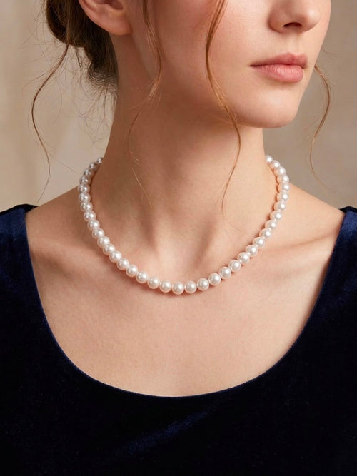 Classic white Akoya pearl necklace worn at the collarbone