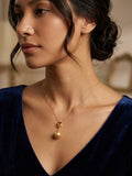Golden South Sea pearl pendant with citrine worn with a navy dress