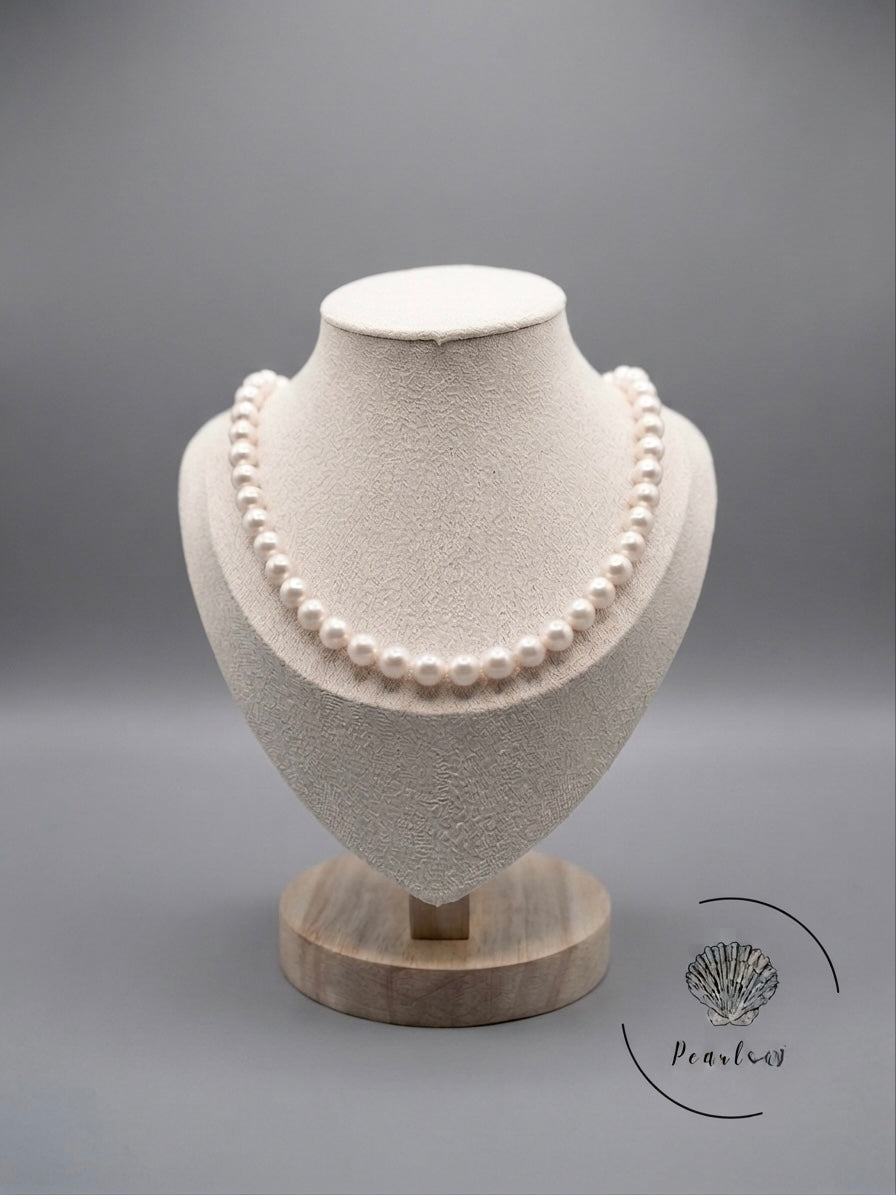 Classic white Akoya pearl necklace on a display bust