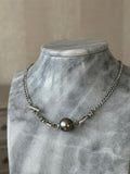 925 silver curb chain necklace with Tahitian pearl on a marble bust