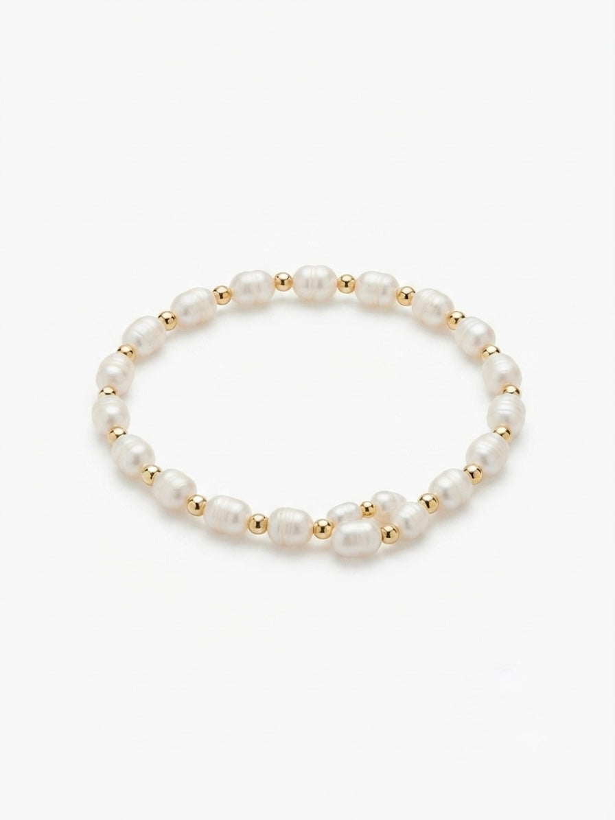 Freshwater pearl and gold bead stretch bracelet on a white background