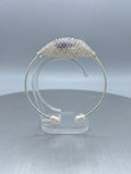 Silver sparkle freshwater pearl cuff on a clear display stand