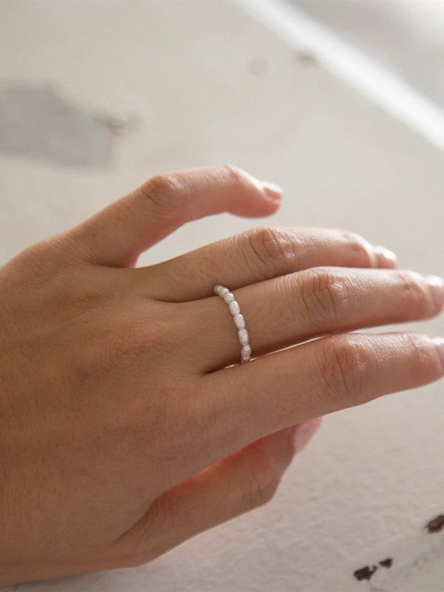 Freshwater baby pearl stacking ring worn on the finger