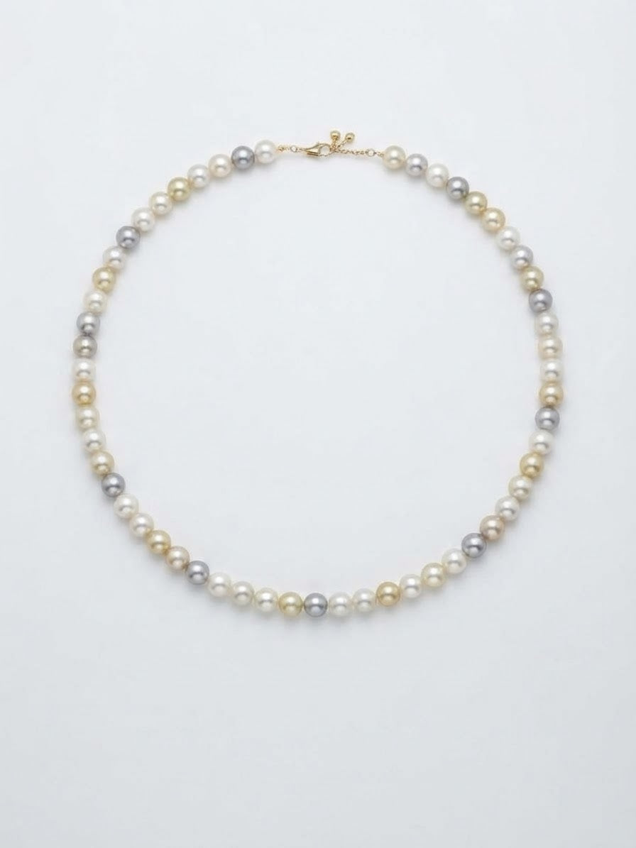 Multicolour Akoya pearl necklace laid flat on a white background