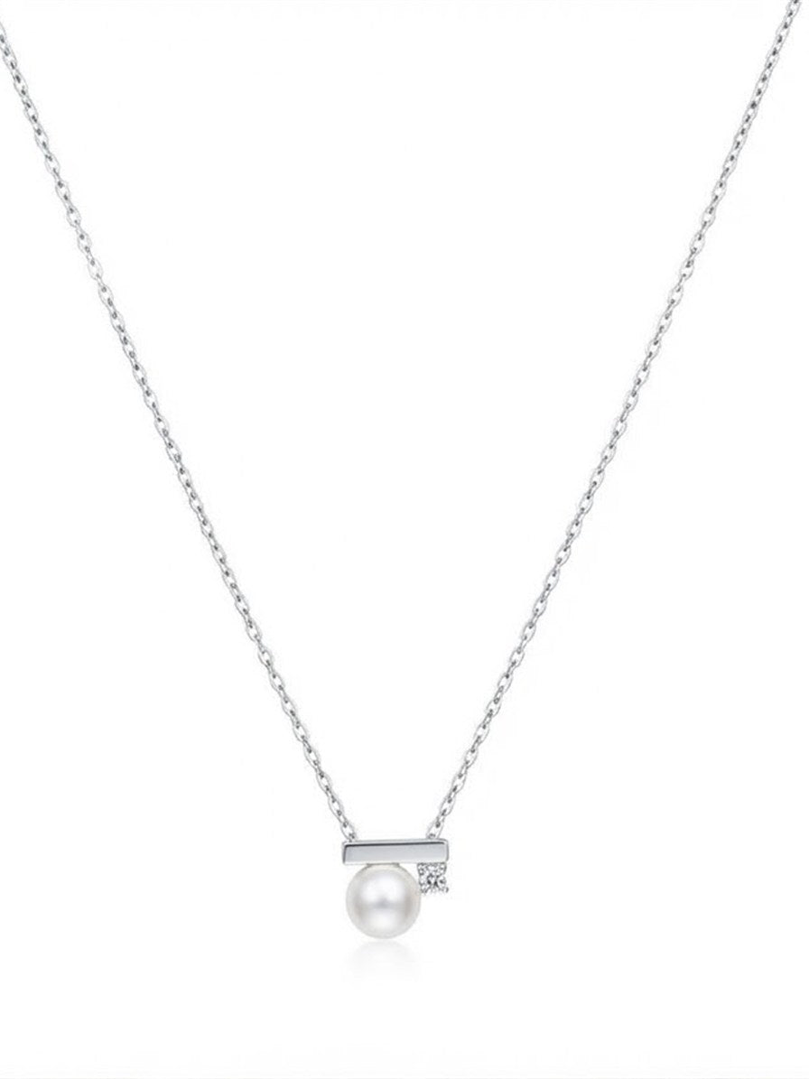 Akoya pearl bar pendant with sparkling stone on a silver chain, white background