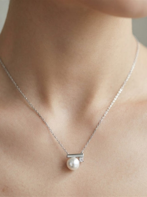 Akoya pearl bar pendant worn on the neck