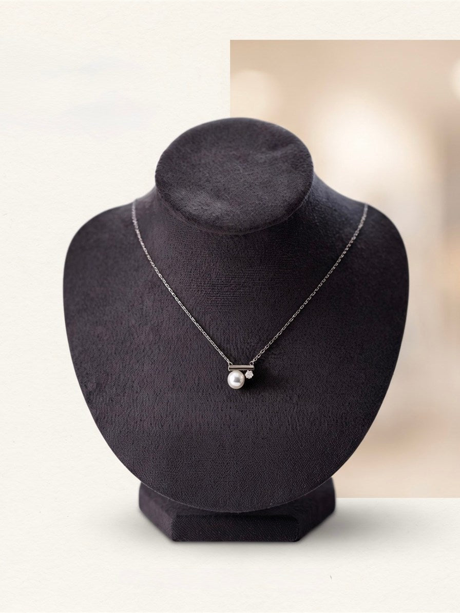 Akoya pearl bar pendant on a dark velvet display bust
