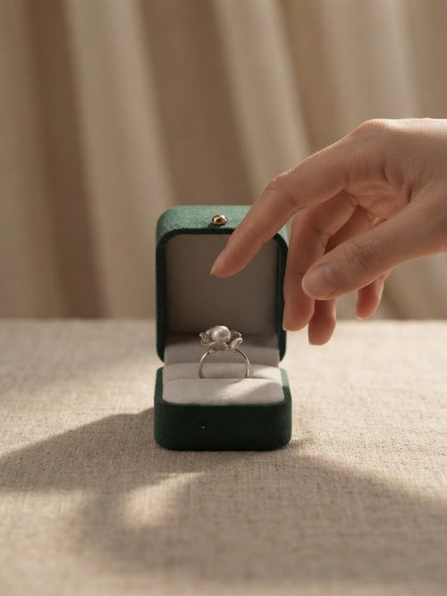 Akoya pearl petal ring in a green velvet ring box