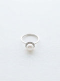 Akoya pearl halo ring in silver on white background