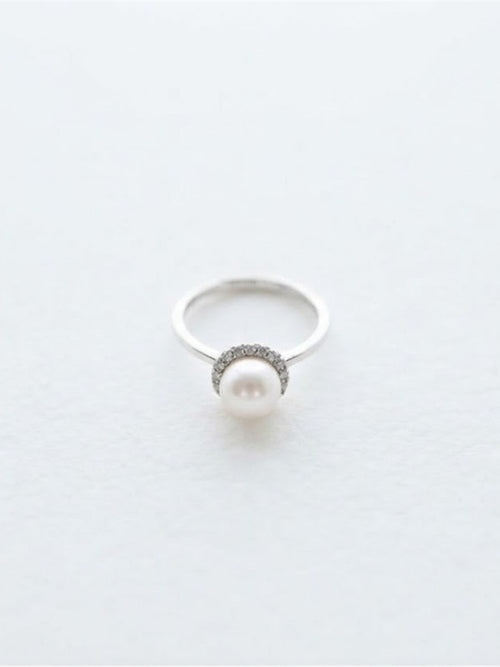 Akoya pearl halo ring in silver on white background