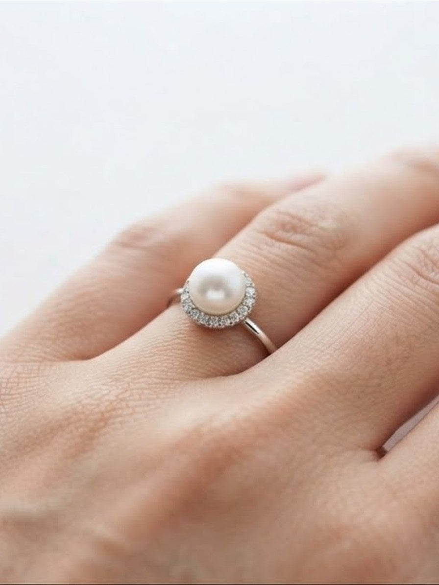 Akoya pearl halo ring worn on the hand