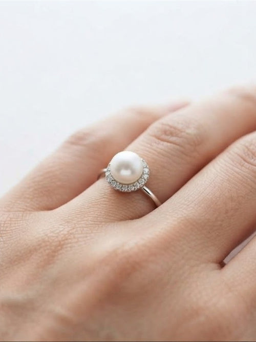 Akoya pearl halo ring worn on the hand
