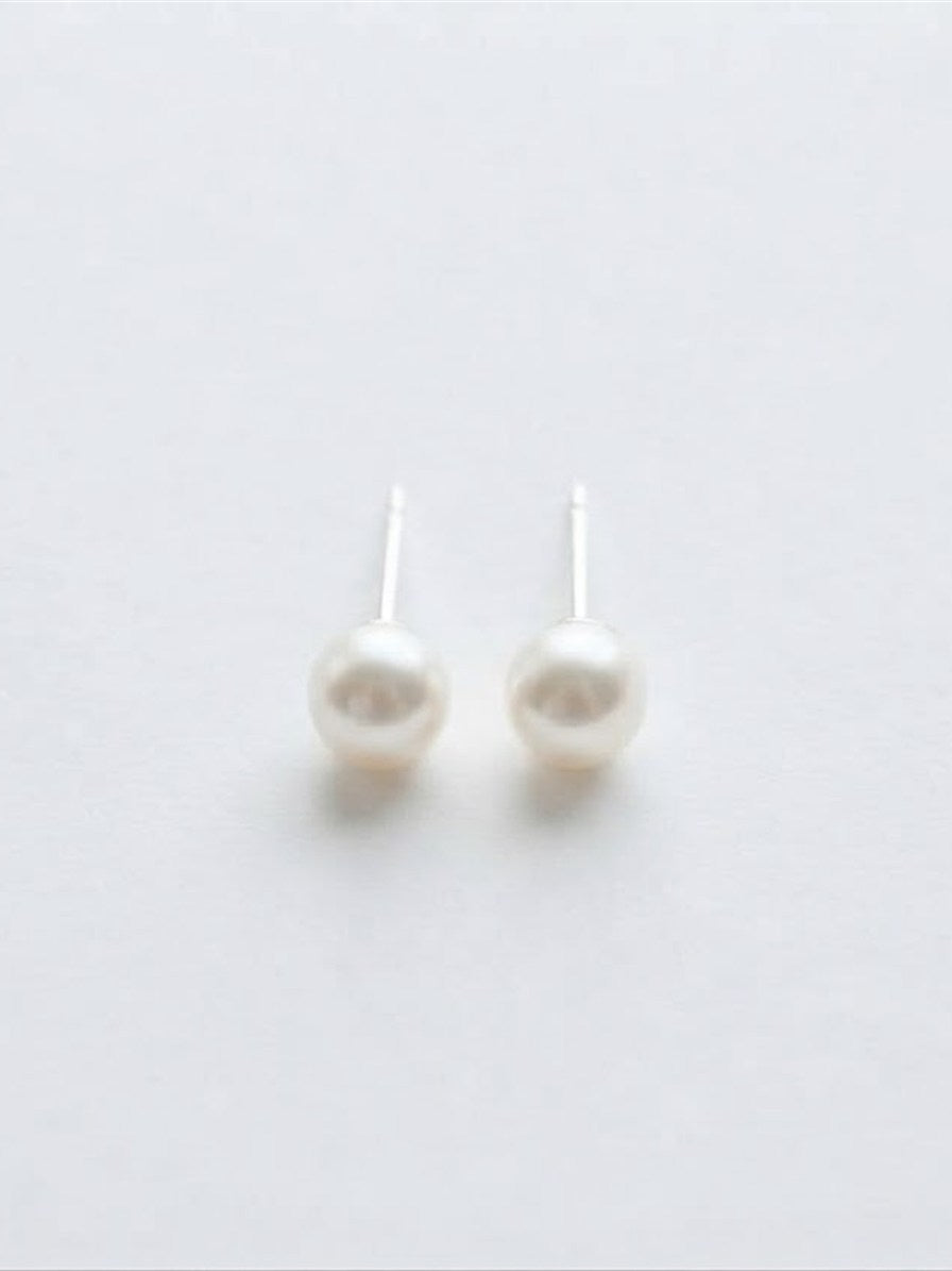 Classic Akoya pearl stud earrings in 18K white gold on white background