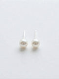 Classic Akoya pearl stud earrings in 18K white gold on white background