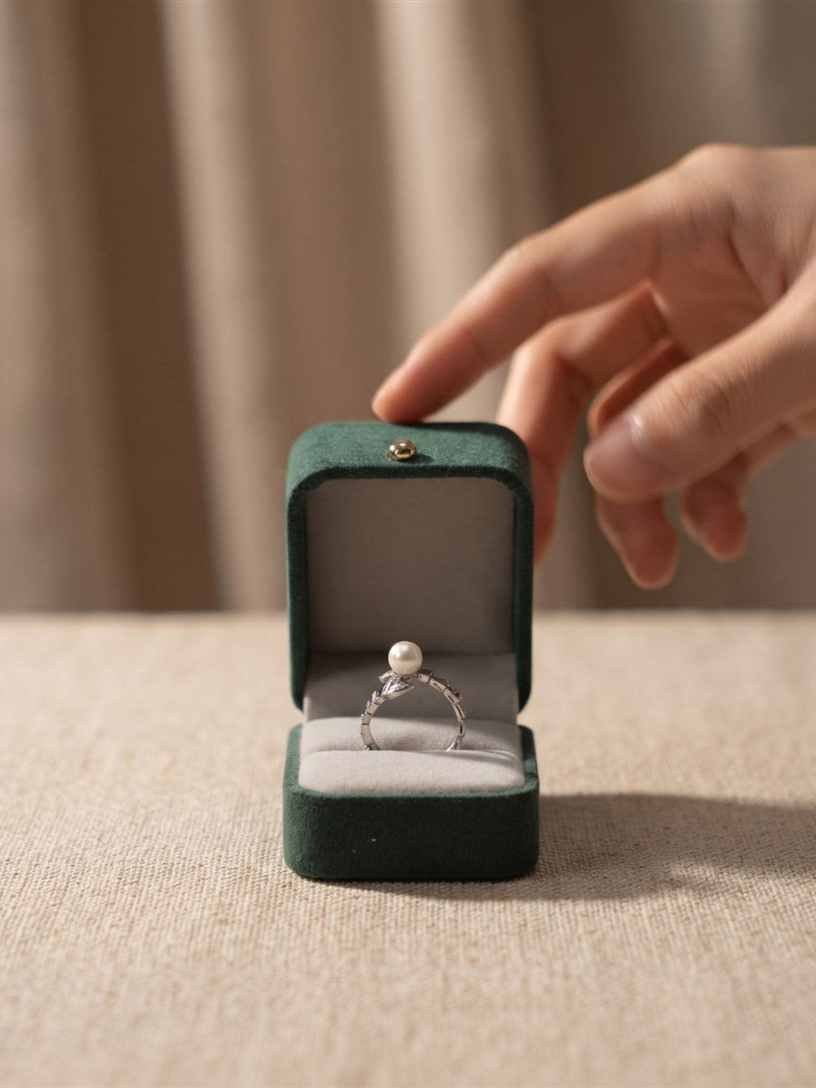 Akoya pearl wrap ring in a green velvet ring box