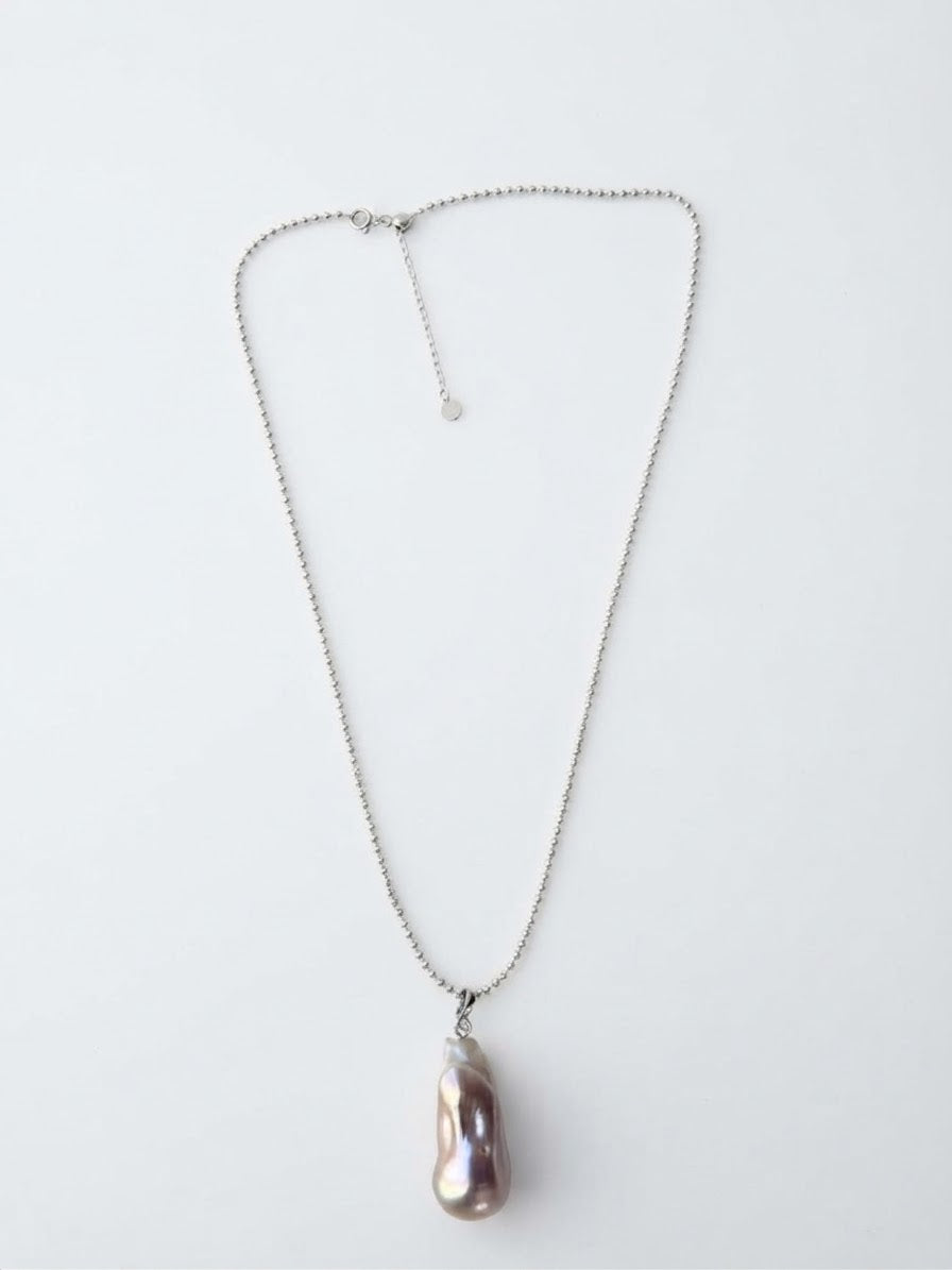 Baroque freshwater pearl pendant on a silver bead chain, white background