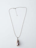 Baroque freshwater pearl pendant on a silver bead chain, white background