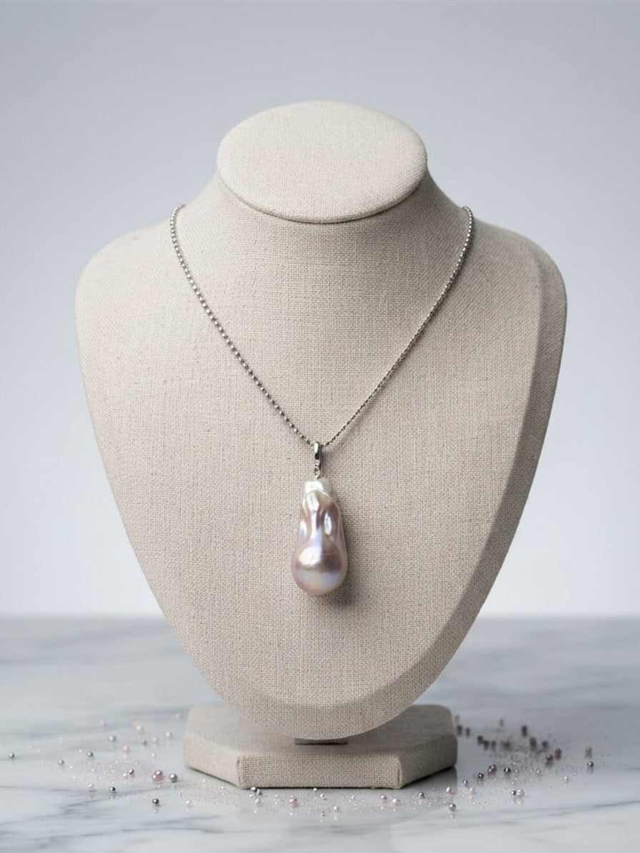Baroque freshwater pearl pendant on a linen display bust
