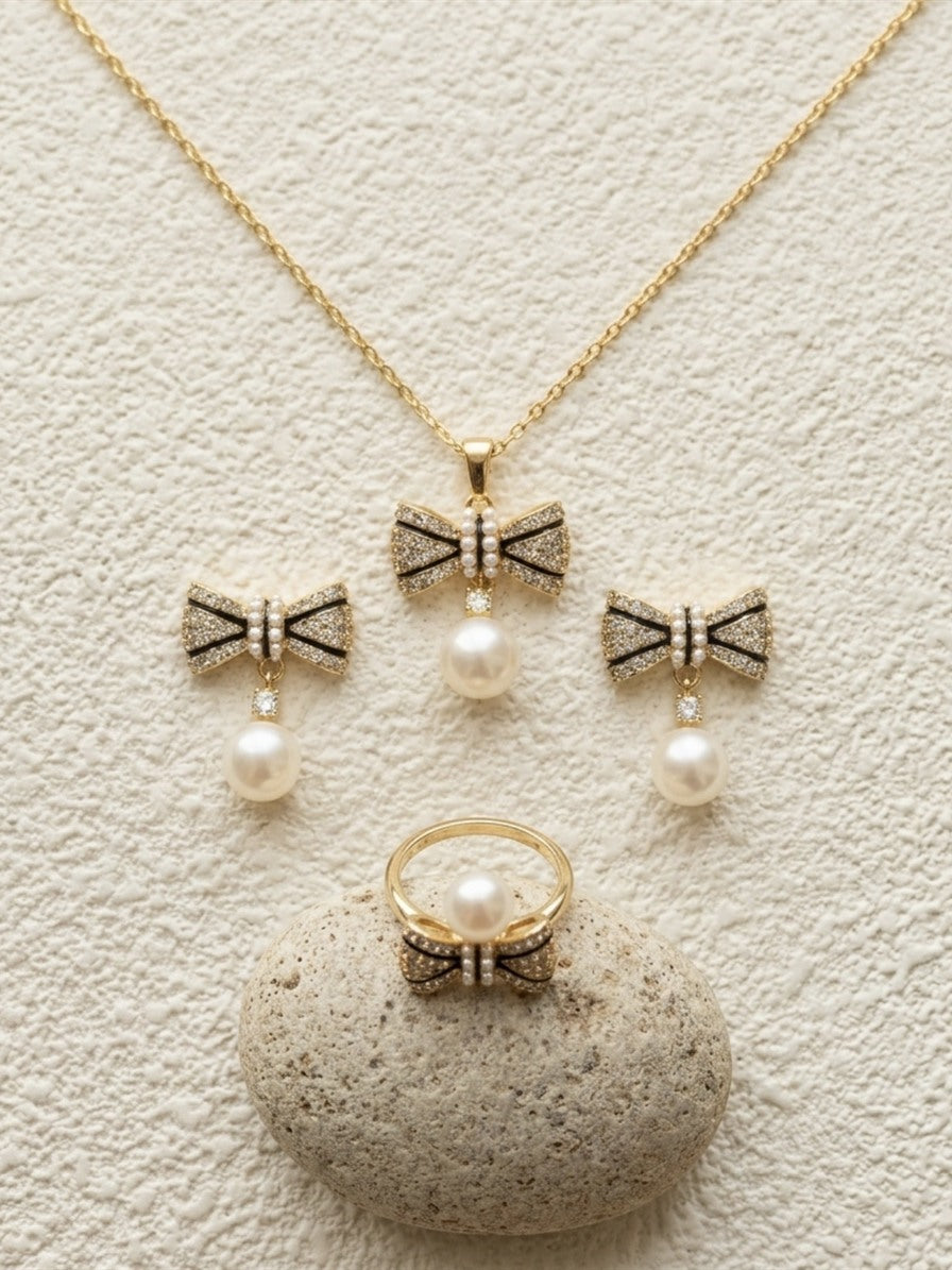 Bow freshwater pearl set: pendant necklace, drop earrings and ring in gold tone with sparkling stones