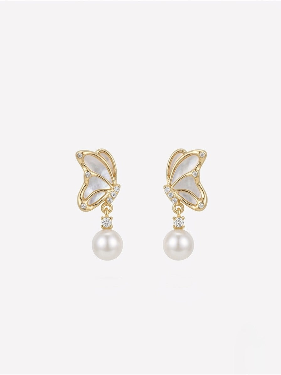 Butterfly drop earrings with freshwater pearls, close-up