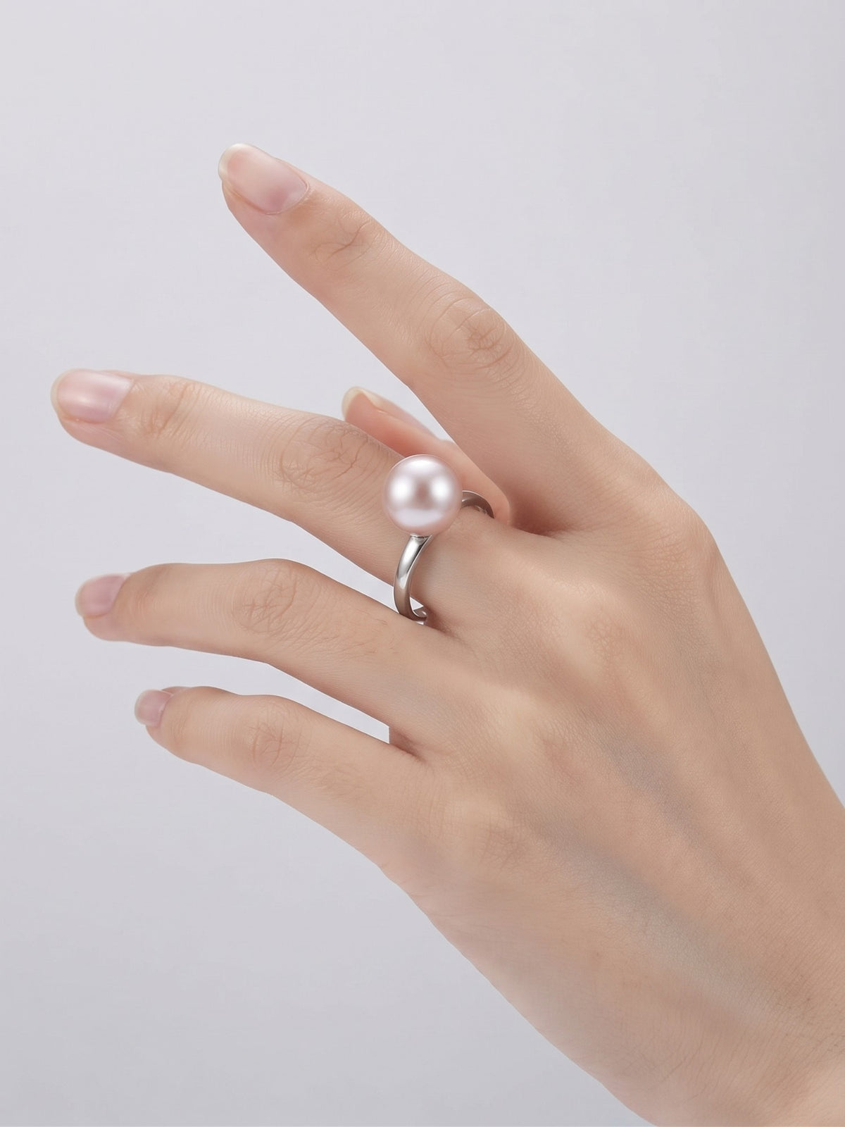 Classic lavender pearl solitaire ring worn on the hand