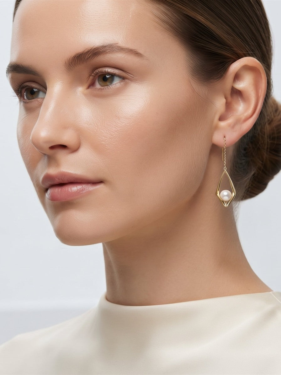 18k gold Akoya pearl drop earring worn by a model