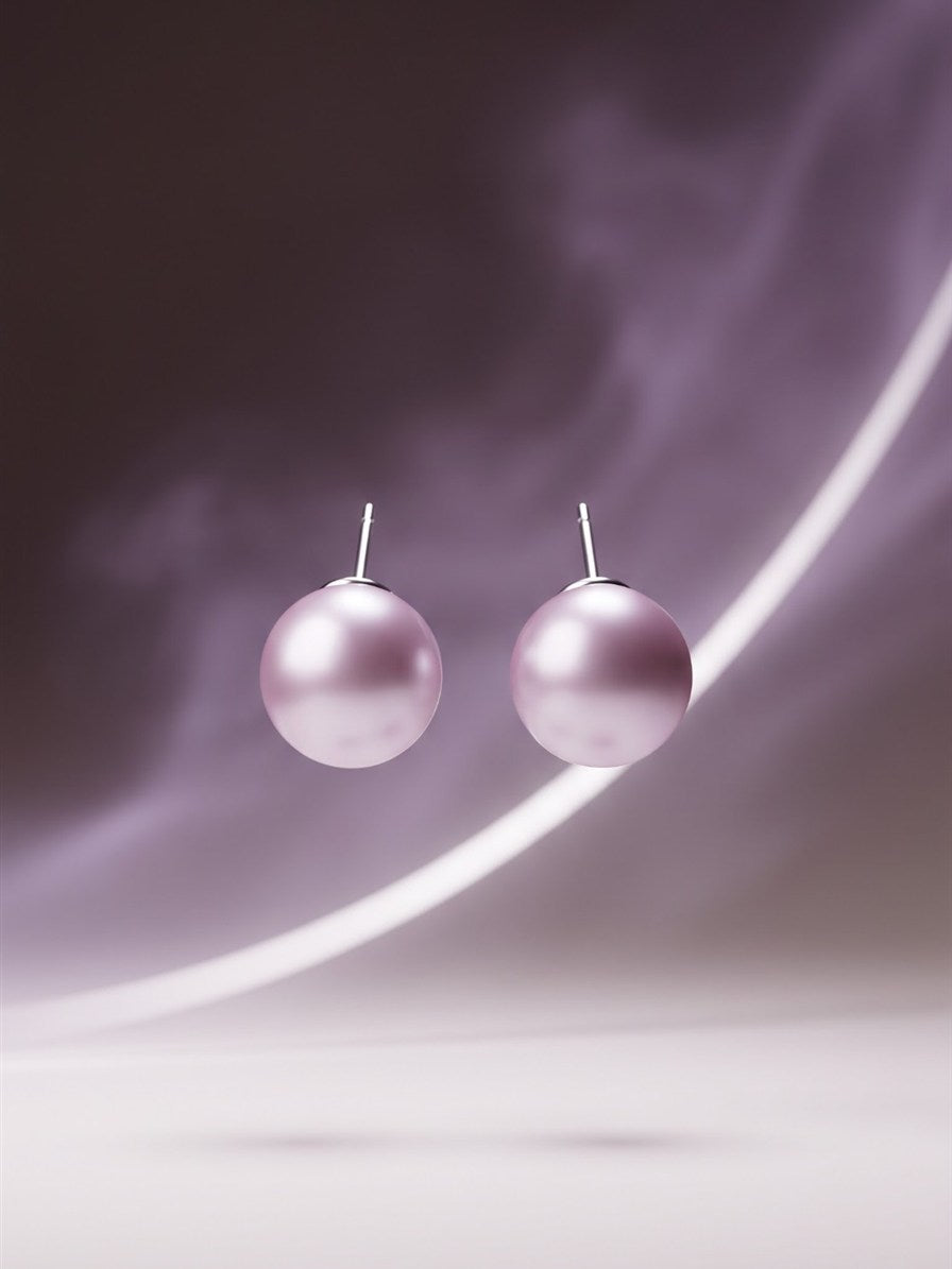 Large lavender pearl stud earrings on a soft purple background