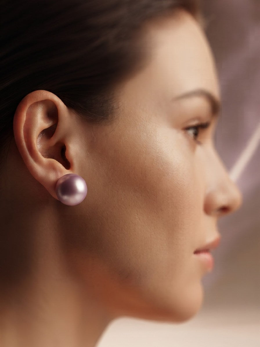 Large lavender pearl stud earring worn on the ear