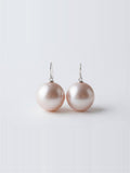 Large blush lavender pearl drop earrings on silver hooks, white background