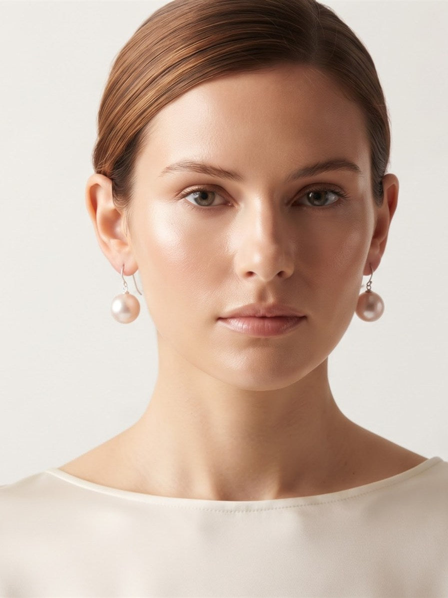 Model wearing large blush lavender pearl drop earrings