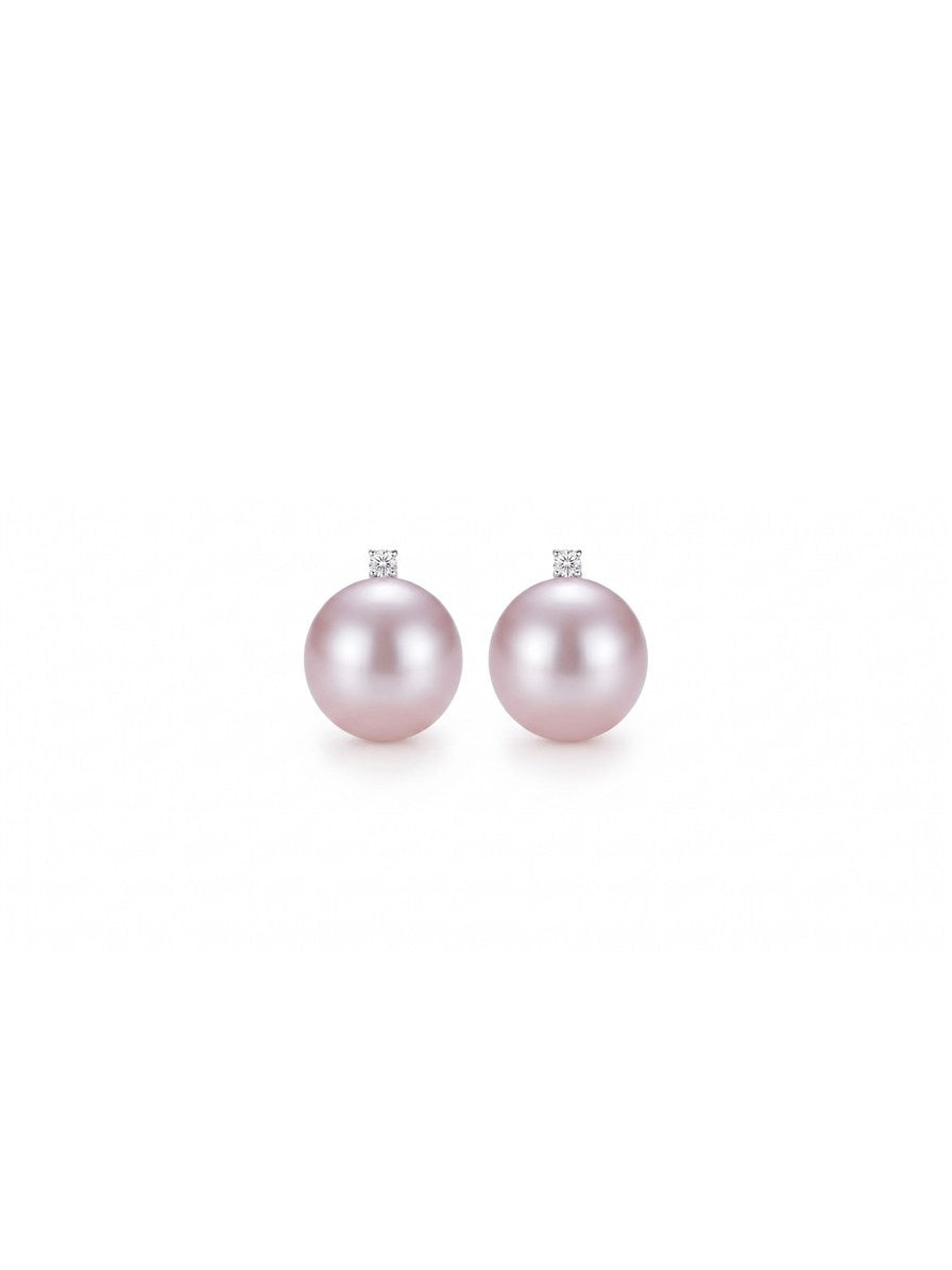 Large lavender pearl earrings topped with a sparkling stone, white background