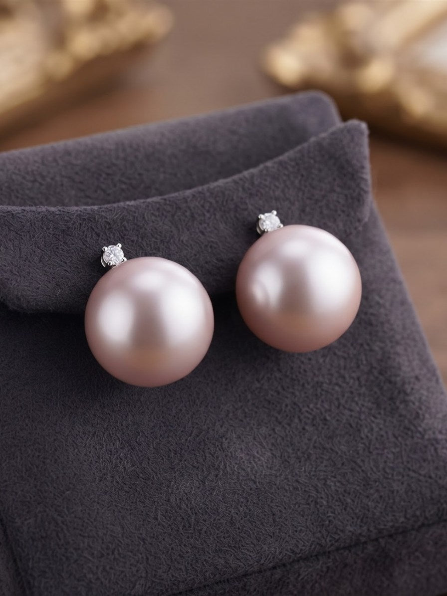 Large lavender pearl earrings displayed on a grey velvet stand