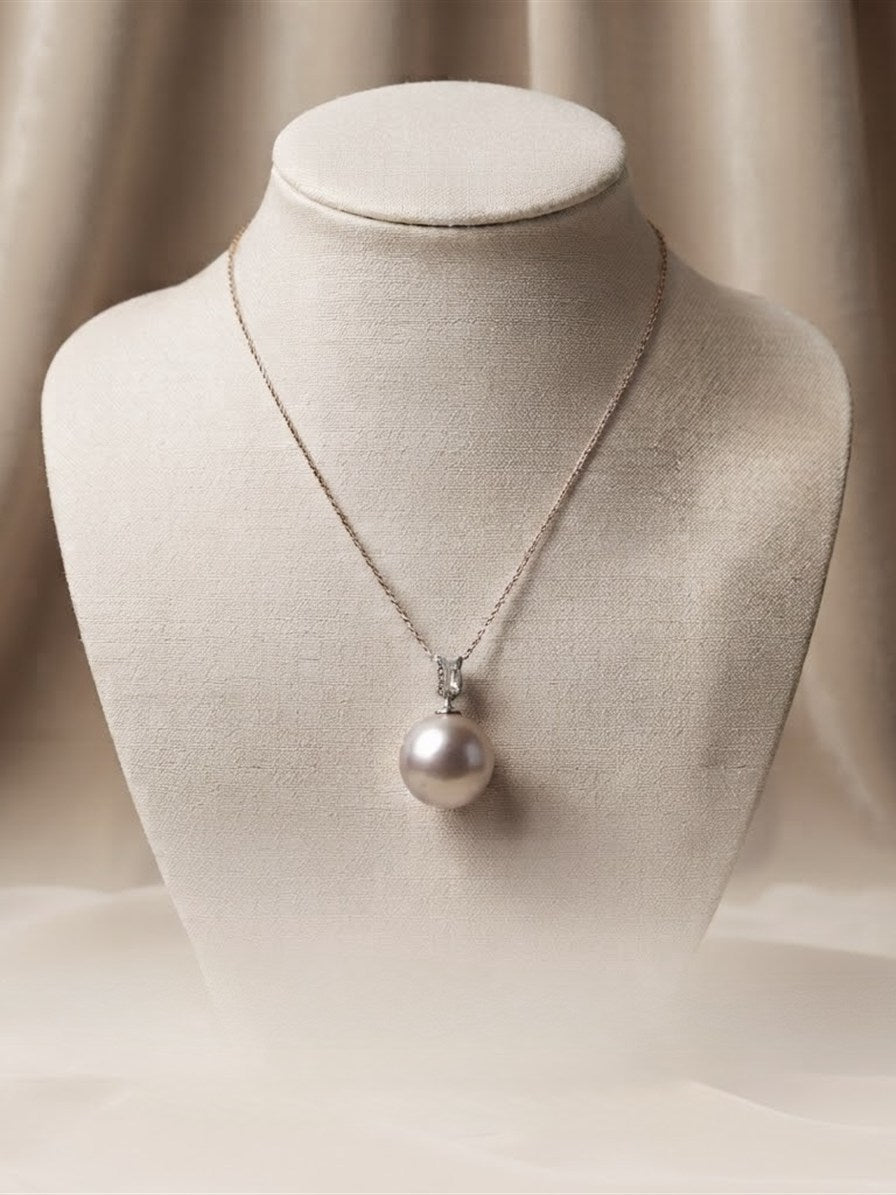 Large lavender pearl pendant on a linen display bust