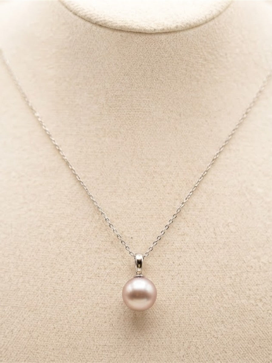 Classic lavender pearl pendant necklace on a linen display bust
