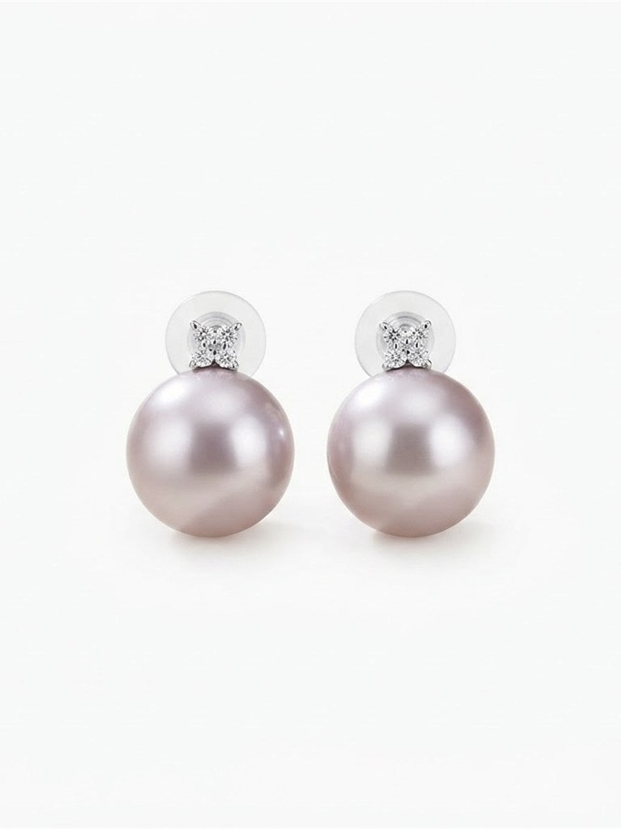 Large lavender pearl earrings with four-stone sparkling cluster on white background