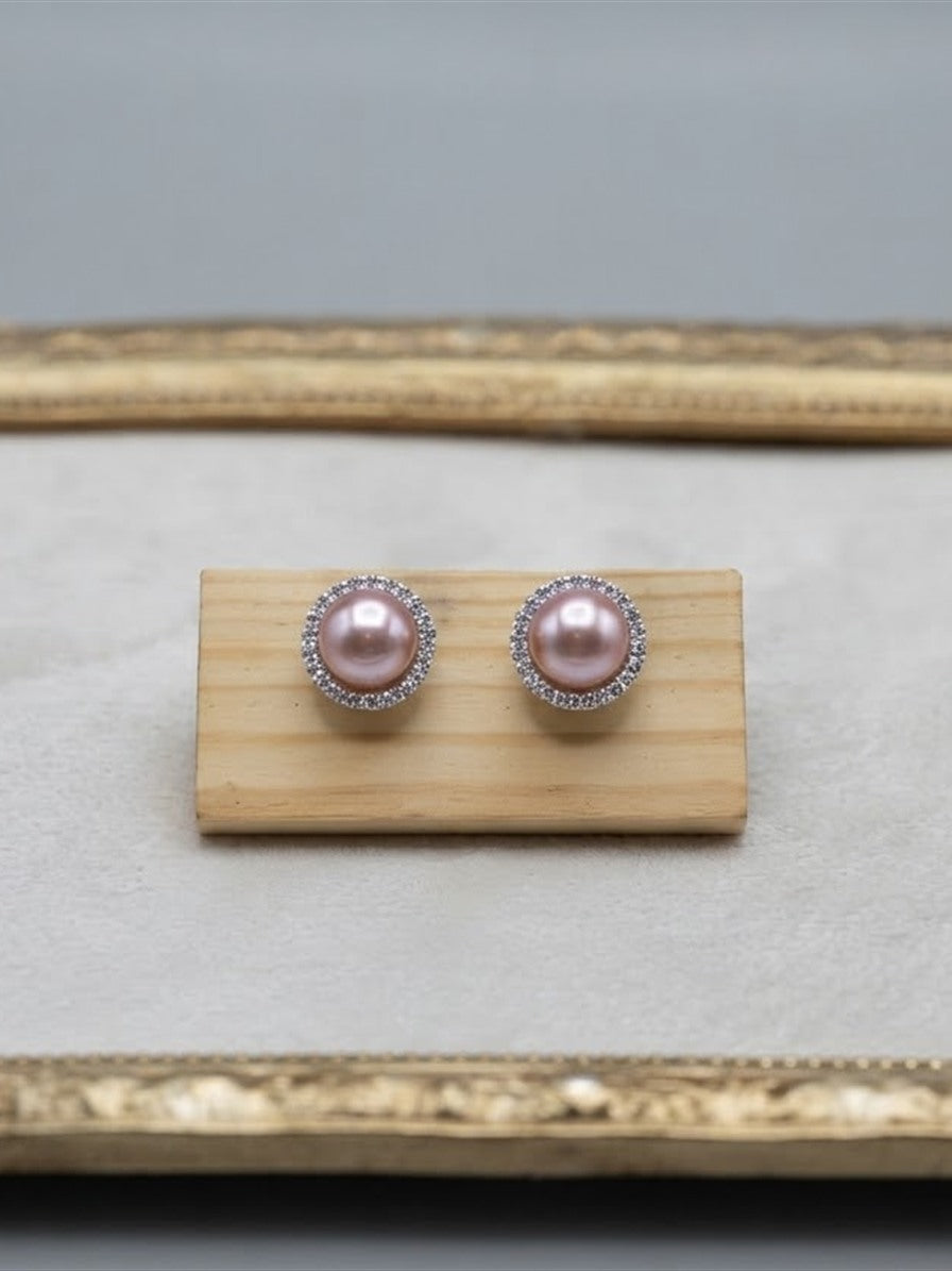Lavender pearl halo stud earrings displayed on a gold frame tray