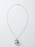 Large lavender pearl pendant with sparkling leaf cap on a silver chain, white background