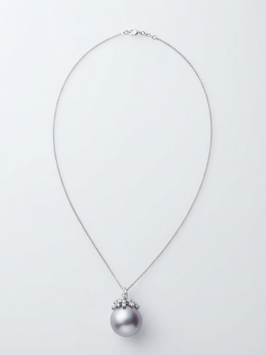 Large lavender pearl pendant with sparkling leaf cap on a silver chain, white background