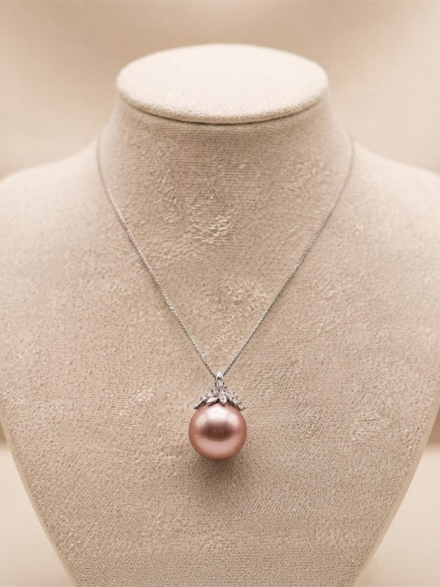 Large lavender pearl pendant with leaf cap on a suede display bust