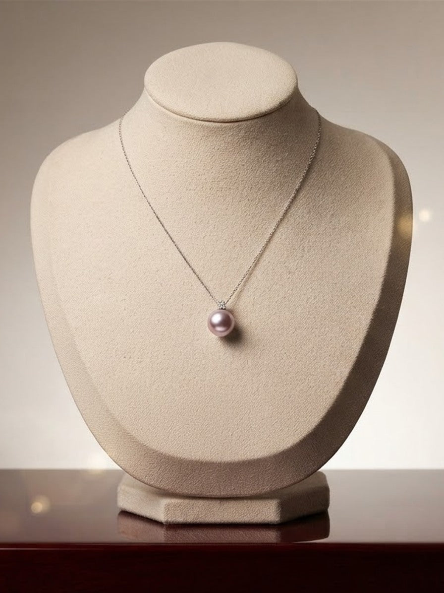 Lavender pearl pendant necklace on a display bust