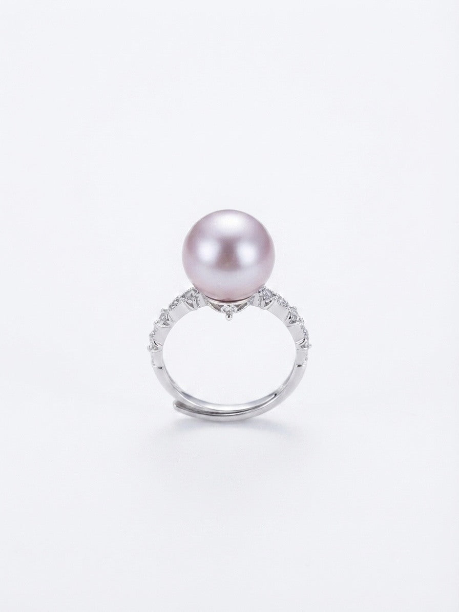 Vintage lavender pearl ring with sparkling stone band on a white background
