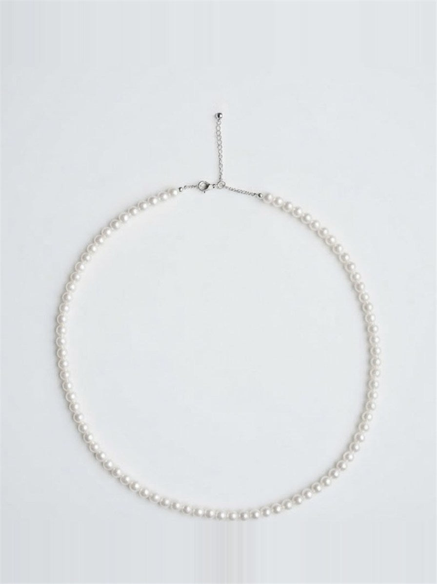 Dainty white freshwater pearl strand necklace with silver clasp on white background