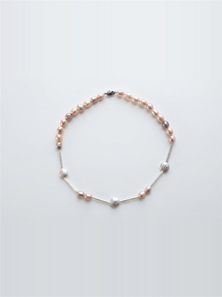 Multicolour freshwater and stick pearl necklace on white background