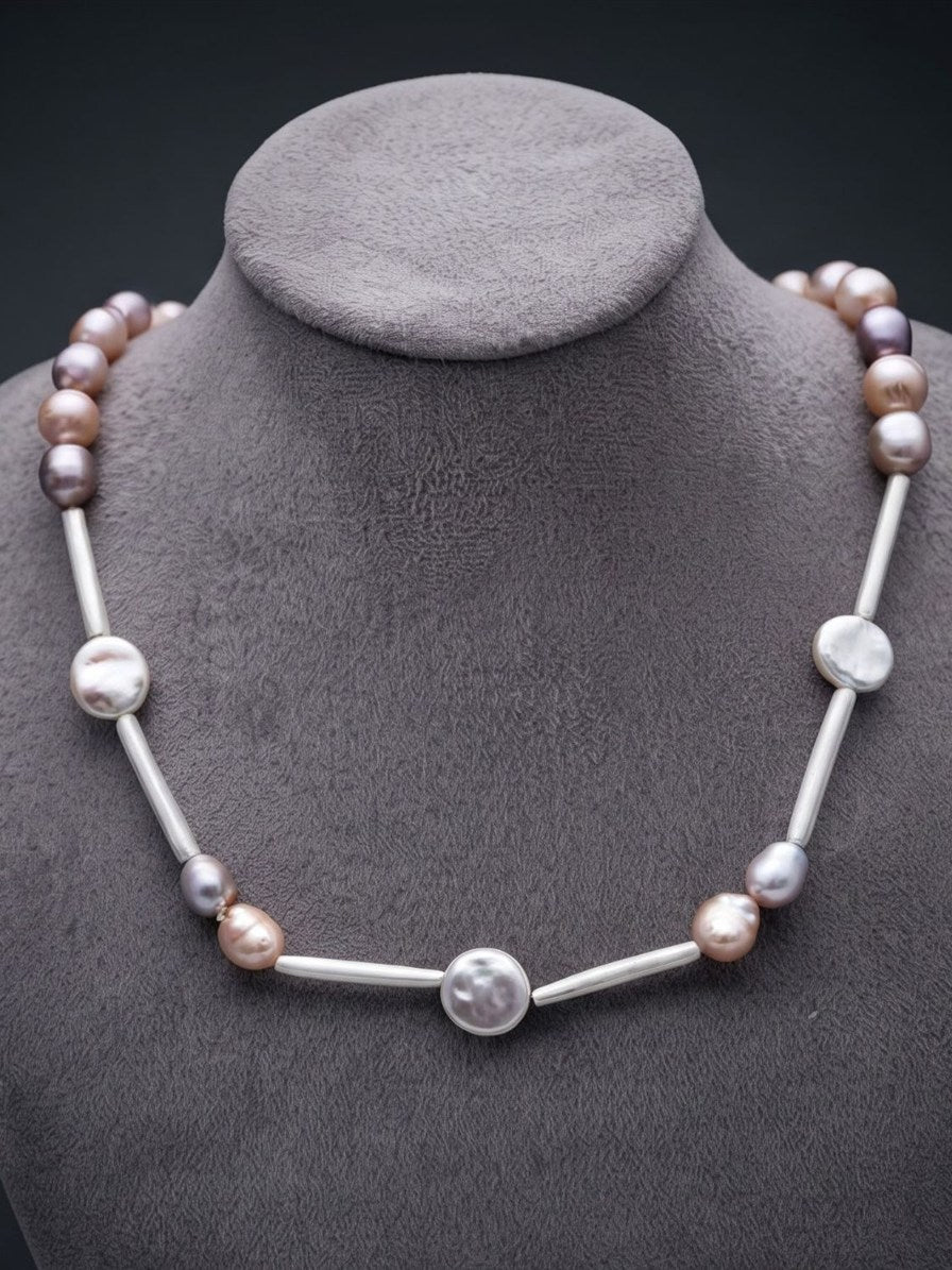 Multicolour freshwater and stick pearl necklace on a grey display bust