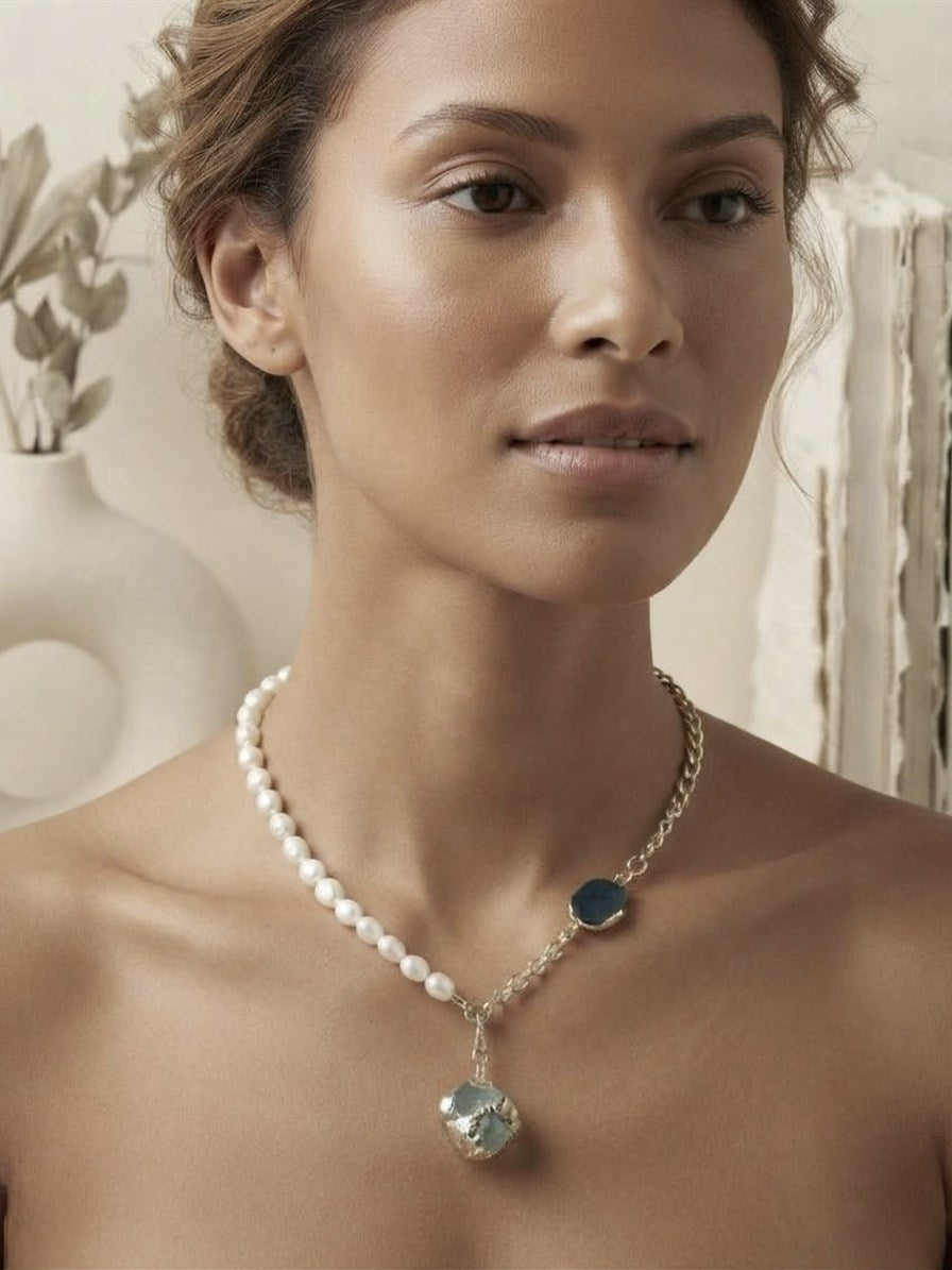 Freshwater pearl and blue raw stone statement necklace worn on the neck