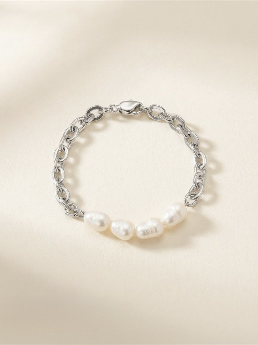 Freshwater pearl and chunky silver-tone chain bracelet on cream background