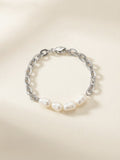 Freshwater pearl and chunky silver-tone chain bracelet on cream background