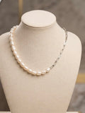 Half freshwater pearl, half silver paperclip chain necklace on a linen bust